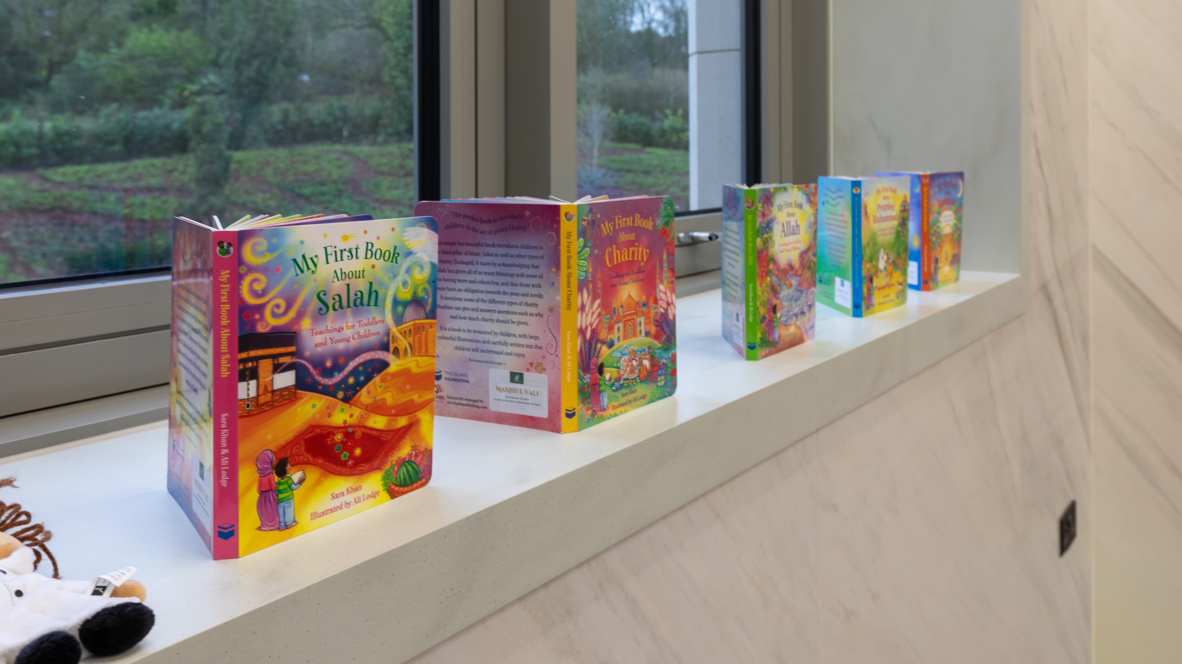 Children’s Islamic picture books lined up along a windowsill