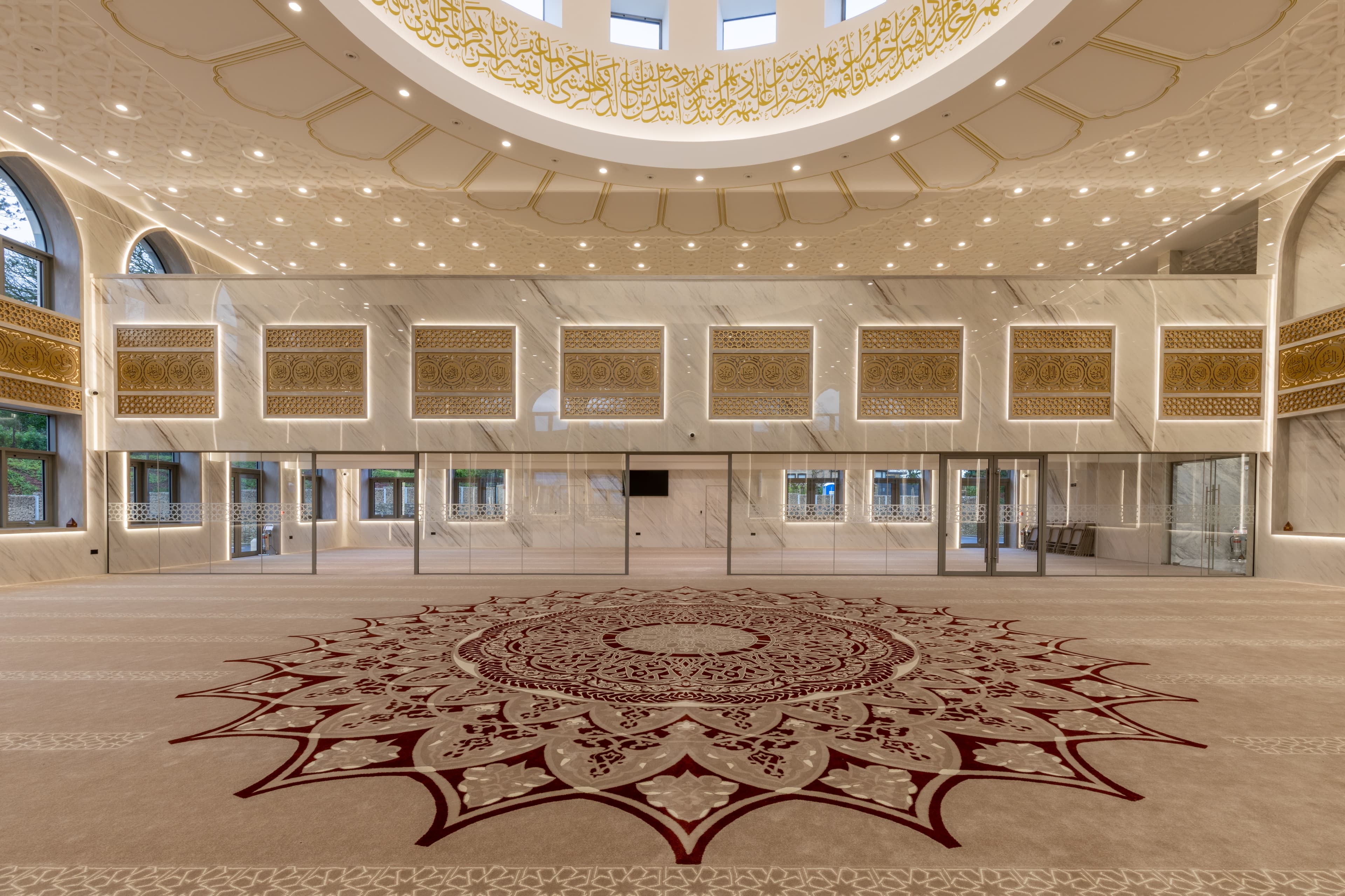 The main prayer hall with its deep red carpet medallion directly beneath the dome.